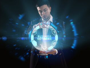 Business, Technology, Internet and network concept. Young businessman working on a virtual screen of the future and sees the inscription: Business network