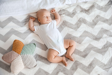 Cute little baby sleeping on bed at home