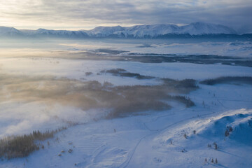 Aerial view of North Chuya Mountain Range and Chuya Highway (Chuysky Trakt) in winter. Altai Republic, Siberia, Russia..
