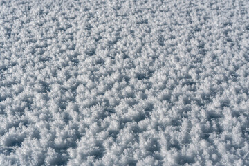 Close up view of the lying snow on a sunny day.