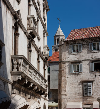 Old streets, architecture. Old facades and red tiled roofs. Scene from the old city of Split and the view of old bell tower