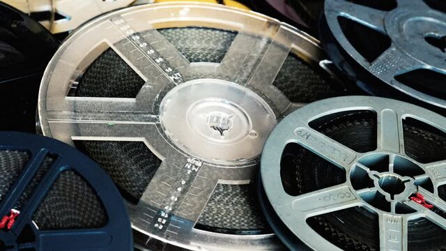 Movie background concept panning on many different 8mm old vintage film reels