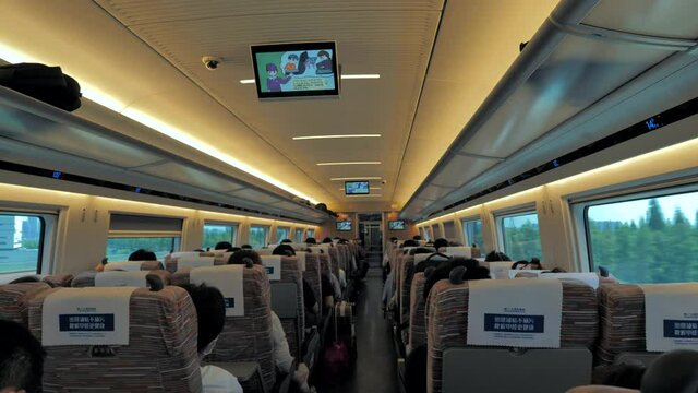 Shanghai, China - August 12, 2020: Inside interior of a coach of the China railway high speed bullet train with passengers. Backview.
