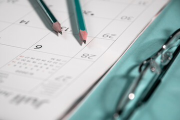 Fototapeta premium blank calendar for note and pencils with glasses, for work management.