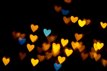 Valentine grunge heart shaped lights background. Yellow gold and blue heart-shaped on black background Colorful lighting bokeh for decoration Valentine, Love Pictures background