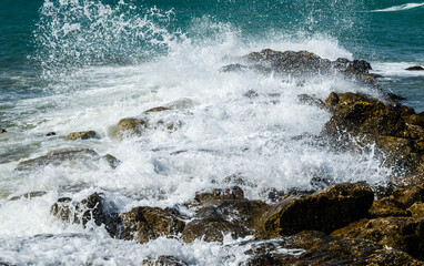 Close-up of sea waves breaking on the rocks of Vilanova y la Geltru beach