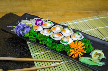 Delicious hossomaki on the decorated plate