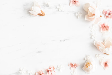 Flowers composition. White and pink flowers on marble background. Flat lay, top view