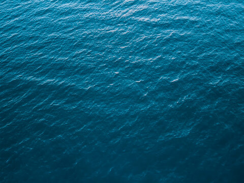 Top view of deep cold sea, texture of small waves. Dark sea background. Texture of water in the ocean. © malshak_off