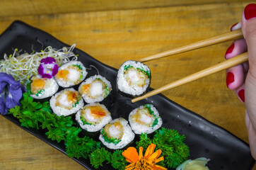 Delicious hossomaki on the decorated plate