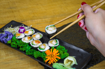 Delicious hossomaki on the decorated plate