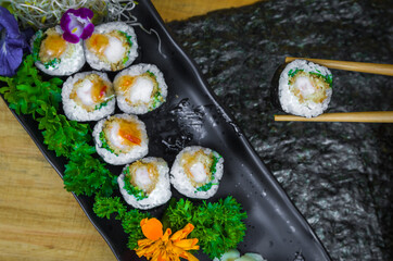 Delicious hossomaki on the decorated plate