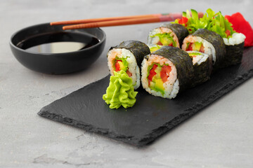 Vegeterian sushi roll with vegetables on stone plate