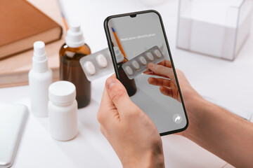 Man using a phone app to recognize unknown pills
