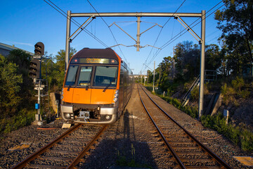 Naklejka premium Commuter Train fast moving through a Station in Sydney NSW Australia