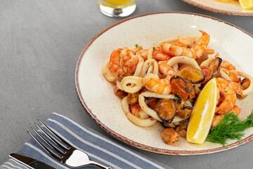 Stir fried seafood with sauce on plate with napkin