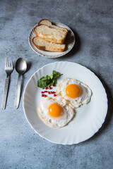 Bread slices and egg poaches are a popular breakfast ingredient. Top view, selective focus.