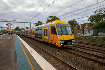 Naklejka na ściany i meble Commuter Train fast moving through a Station in Sydney NSW Australia