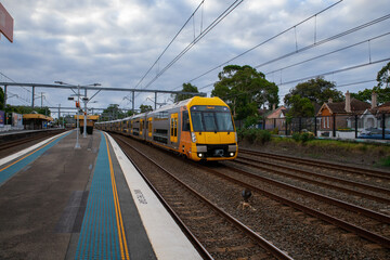 Commuter Train fast moving through a Station in Sydney NSW Australia