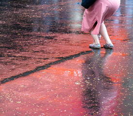 Red refelctions of woman on wet pavement 1969