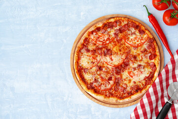 Delicious pizza with sausages on gray background