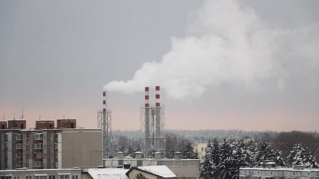 Smoke rises from the chimney on a cloudy winter day.
