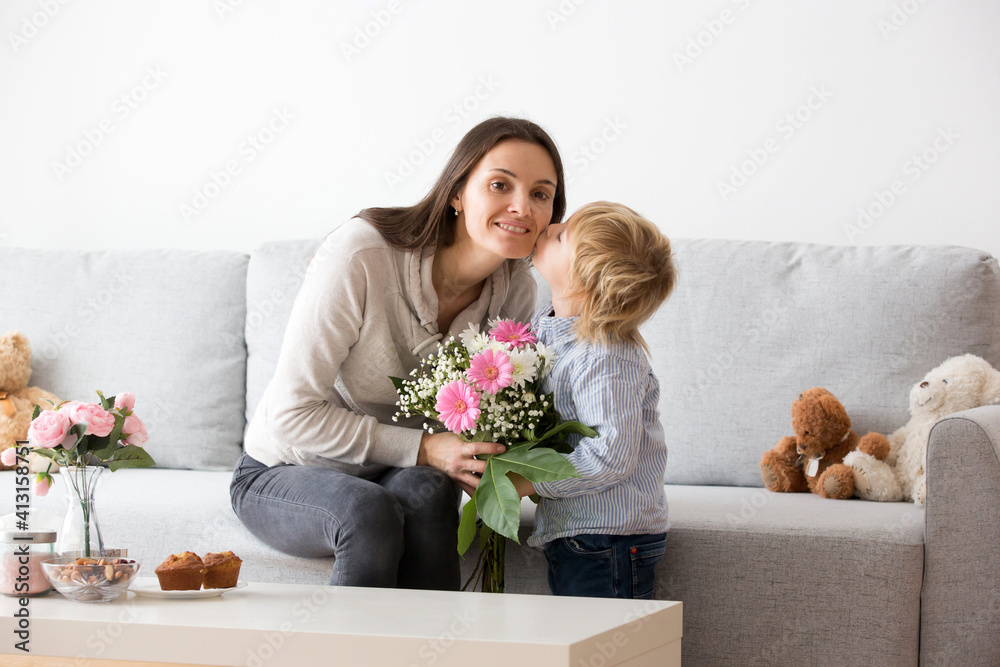 Canvas Prints Beautiful blond boy, giving mother flowers and box with little gift for mothers day