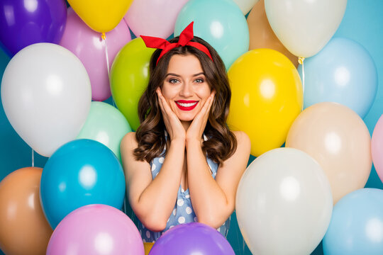 Charming pretty girl enjoy event party celebration touch hands face feel grateful wear red lipstick dotted blue headband dress singlet tank-top on air balls baloons background