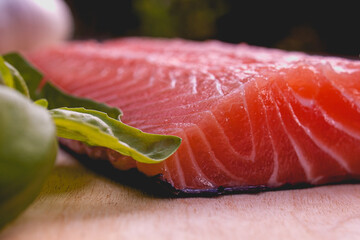 close up of cutted salmon on wooden plate