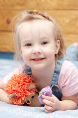 portrait of cute little girl playing with a toy