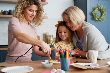 Three generations of women preparation Easter decoration together