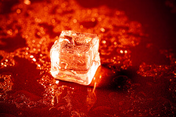 Red ice ball reflection on black background.