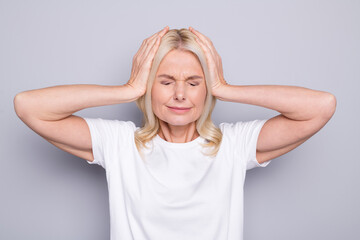 Portrait of blond stressed old lady hands head wear white cloth isolated on grey color background