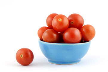 Cherry tomatoes in ceramic bowl on white background