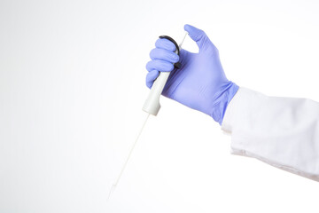 hand with blue glove holding a pipette isolated on white background