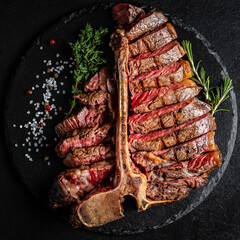 Barbecue Wagyu T-Bone Steak sliced. porterhouse grilled beef steak Medium rare on stone table....