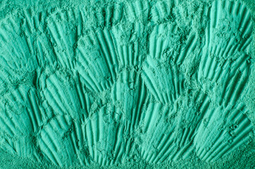 Green cosmetic clay powder (kelp facial mask, spirulina body wrap) texture close up, selective focus. Abstract background with brush strokes.