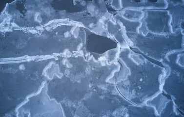 Cracks on frozen lake ice surface