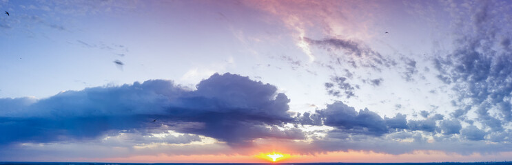 Obraz premium Dawn or sunset over the clouds, blue hour, aerial view.