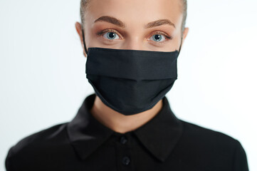 Young woman in black face mask