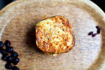 Toast with cheddar cheese and sesame seeds on a wooden tray. breakfast and snack