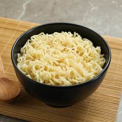 Concept of breakfast with bowl of noodles on gray background