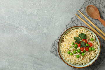 Concept of tasty eating with bowl of noodles on gray background