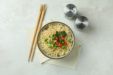 Concept of tasty eating with bowl of noodles on white textured background