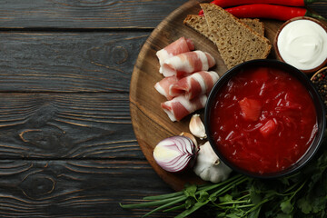 Concept of tasty food with borscht and ingredients on wooden background