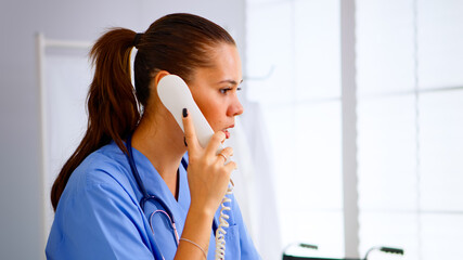 Specialist doctor nurse checking appointment during telehealth communication in hospital. Healthcare physician in medicine uniform, receptionist doctor assistant helping with phone concultation