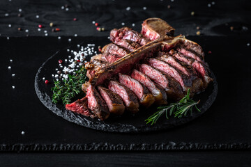 Barbecue Wagu T-Bone Steak. porterhouse grilled beef steak Medium rare with spices on a black table, banner, catering menu recipe place for text, top view. American meat restaurant
