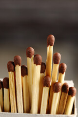 Matches stick out from an open matchbox.