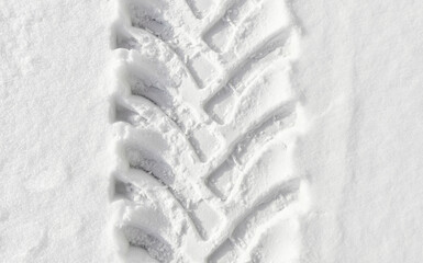 Picture of heavy duty vehicle tire track in snow, abstract background.