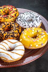 donuts with different flavors of frosting on a platter